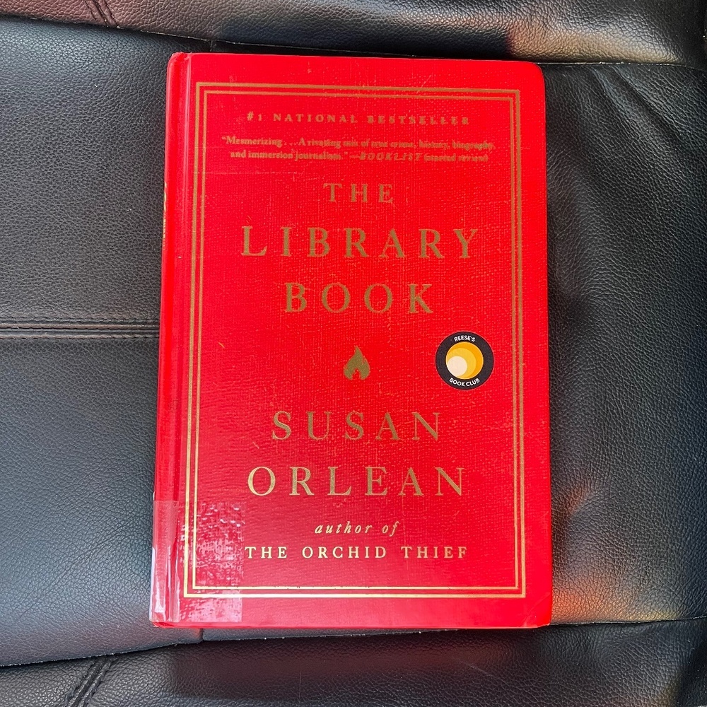 Red Hardcover Book - The Library Book by Susan Orlean